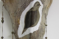 Aviary #4 Small plump brown and black bird outlined in white painted on queen palm