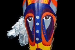 Head of State #1 colorful and patterened face painted on queen palm, with large eyes