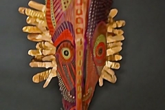 Head of State #14 reds and golds on broad queen palm create face lined with gold paper hair
