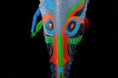 Head of State #16 a soaring bird highlights this face painted in broad strokes on queen palm