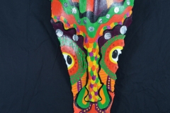 Head of State #8 green, orange, black and yellow patterns dominate on this face painted on queen palm