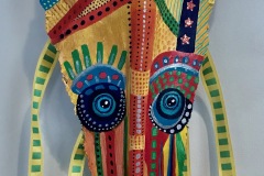 Head of State #19 vibrant blues, yellows, red, green are used to create an elongated image of a persons head, patterns and color blocks Approx. 33"x11"x6"
