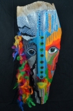 Head of State #11  large eyes stare from vibrantly colored paterning on palm frond Approx. 30” x 14” x 7”