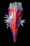 Head of State #15 mythical face round eyes and patterning of blues reds and oranges on queen palm frond Approx. 24” x 8” x 6”